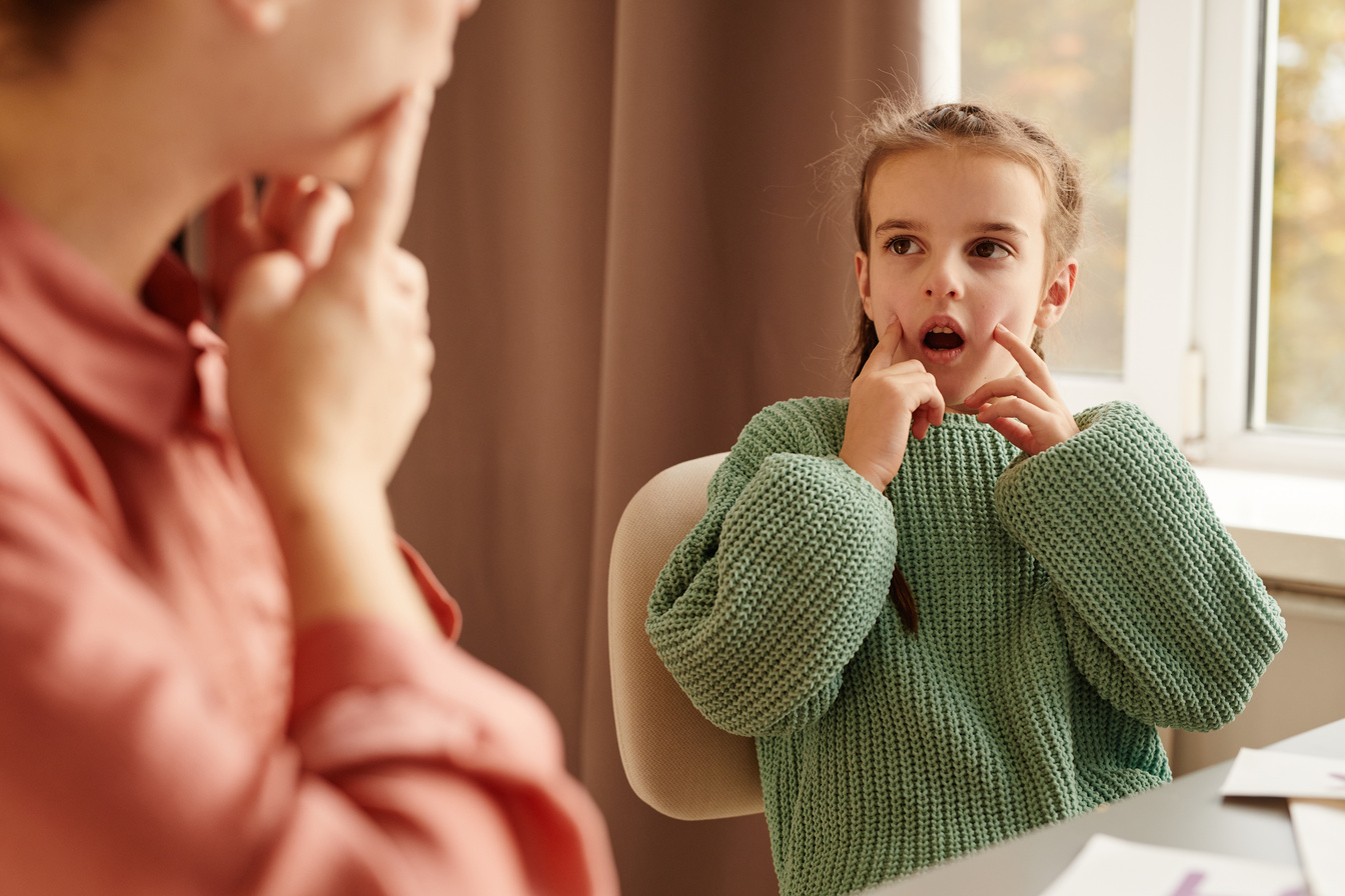 Little Girl Learning Articulation with Teacher