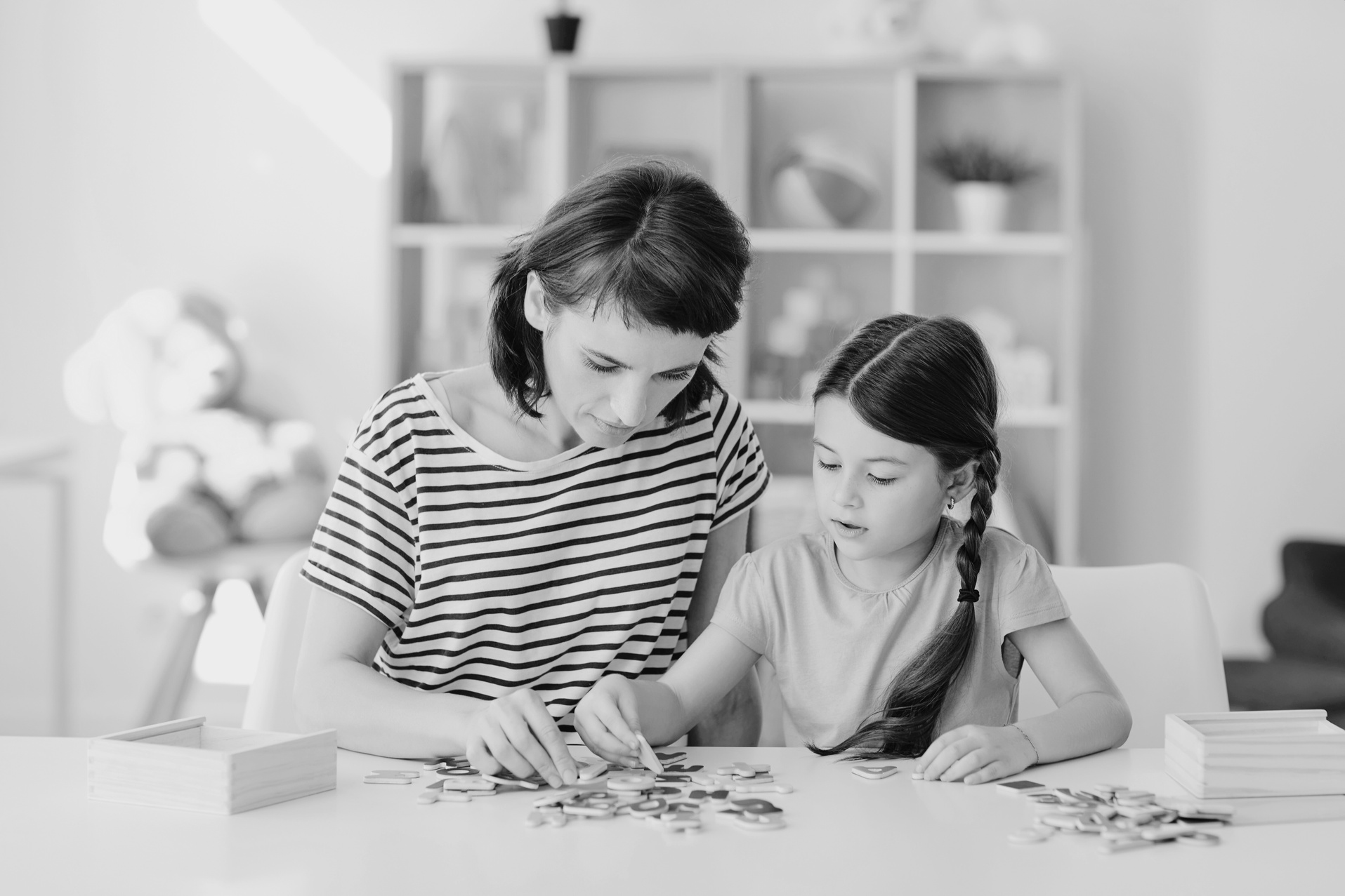 Mother and Daughter Playing Educational Game Arranging Letters into Words in Nursery Room at Home